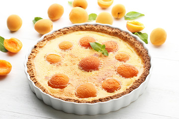Apricot tart on white wooden table