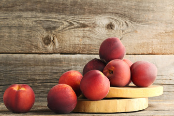 Sweet nectarines on wooden cutting board