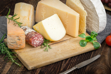 Cheeses with basil, rosemary, tomatoes, grapes and salame.