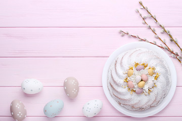 Easter cake with eggs and tree branches on wooden table