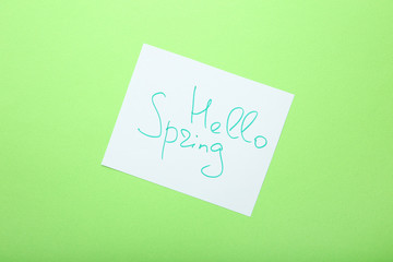 Inscription Hello Spring on green background