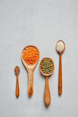 Wooden spoons with lentils and other grains. Handmade spoons.
