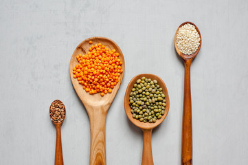 Close-up of wooden spoons with lentils and other grains. Handmade spoons.