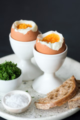 Boiled eggs with sea salt and toasted bread for breakfast. Selective focus