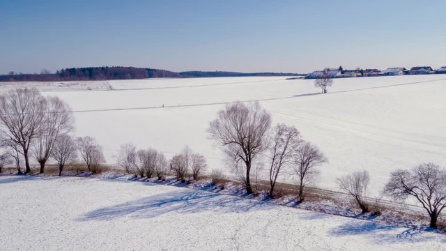 Running over a field in winter filmed with drone