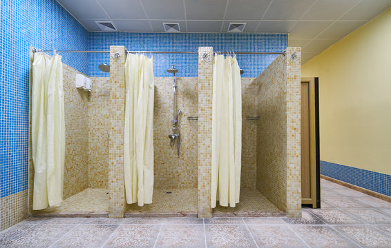 Three Empty Showers in modern Gym Locker Room