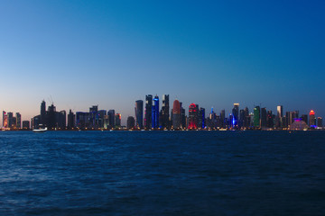 Obraz premium Skyline of West Bay skyscrapers, taken at sunset from the Dhow Harbour. Doha, Qatar.