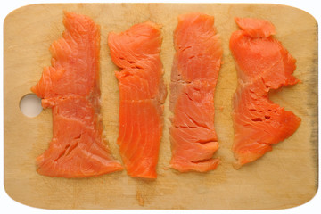 pieces of red fish on a cutting board, isolated