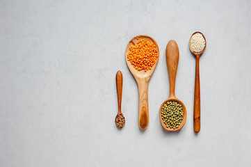 Handmade spoons. Wooden spoons with lentils and other grains.