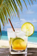 Classic Brazilian cocktail of kaipirinha. Freshly prepared alcoholic beverage on the background of the ocean with space for text