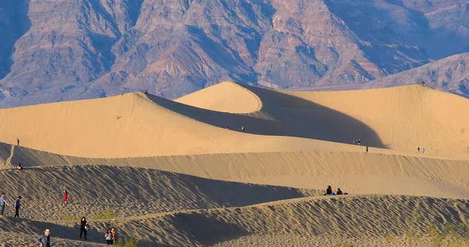 People walking in Mesquite dunes in Death Valley, California, USA