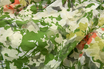 green crinkled textile with leaf motive for background wallpaper