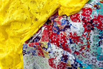 colored crinceld fabric with yellow red with blue flower textile background