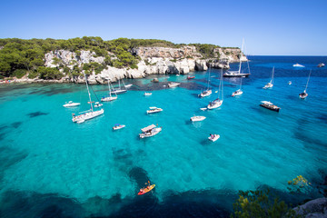 Boats and yachts on Macarella beach, Menorca, Spain