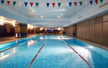 Interior of public swimming pool in a luxury fitness gym.