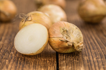 Portion of White Onions on wooden background, selective focus