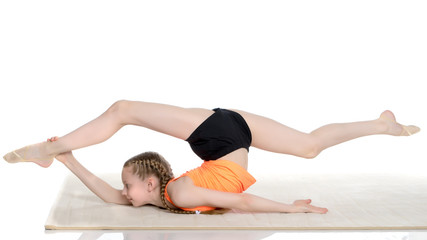 Obraz premium The gymnast performs an acrobatic element on the floor.