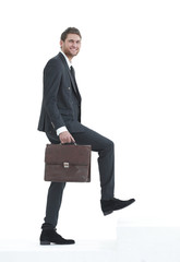 in full growth. a businessman with a leather briefcase walks up.