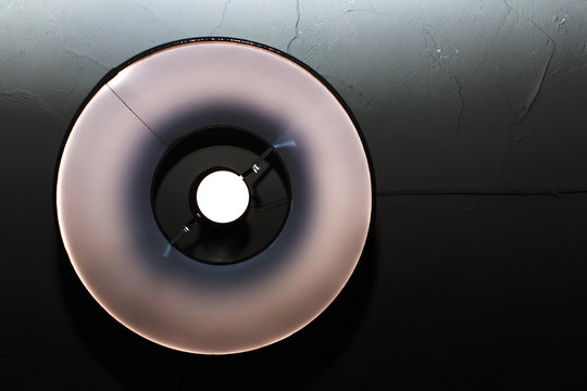 round light bulb on black background