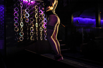 Young sexy dancer dancing on dark background
