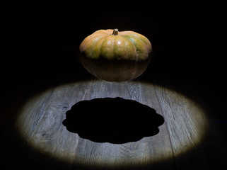 a pumpkin is in weightlessness over a wooden surface