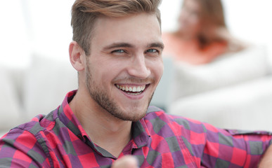 closeup of happy young man showing forward,