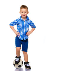 Little boy is playing with a soccer ball.