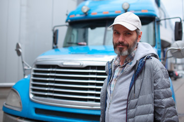 Mature man against truck