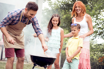 Family on vacation having barbecue