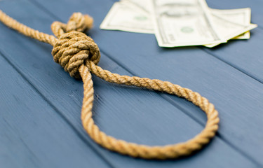 Gallows, rope loop. The concept of suicide because of money.