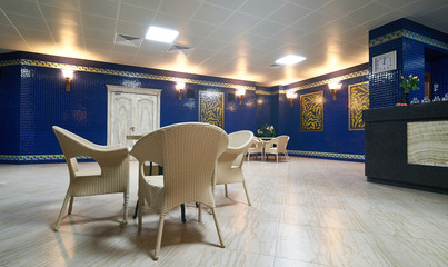Lounge zone interior with chairs and tables in a luxury modern fitness gym                   