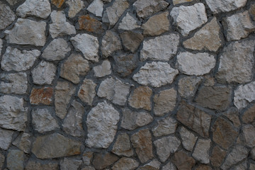 Old granite stone wall texture background close up