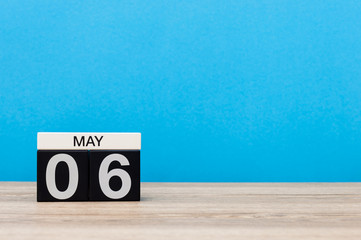 May 6th. Day 6 of month, calendar on turquoise background. Spring time, empty space for text