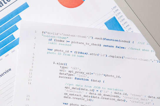 Web developer programming code printed on a piece of paper