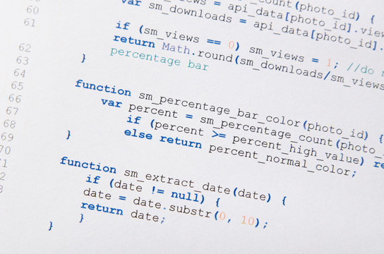 Web developer programming code printed on a piece of paper
