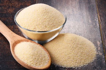 Bowl of semolina on wooden table