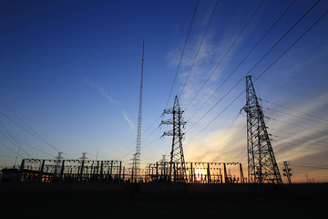 Fototapeta na wymiar A high voltage substation in the sky at sunrise