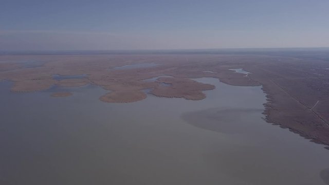 Aerial view of Ferto-Hansag National Park and Ferto (Neusiedl, Neusiedler See) lake. Austria and Hungary border. Original untouched LOG format.