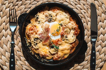 tortilla con potatos. Typical spanish dish with bacon cheese tomato sauce and egg