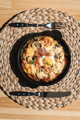 tortilla con potatos. Typical spanish dish with bacon cheese tomato sauce and egg