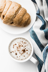 Cappuccino on a striped tablecloth. Morning coffee.