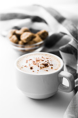 Cappuccino on a striped tablecloth. Morning coffee.