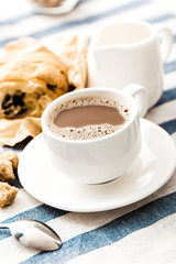 Cappuccino on a striped tablecloth. Morning coffee.