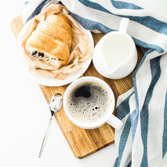 Morning coffee with croissant on the table