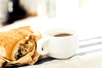 Morning coffee with croissant on the table
