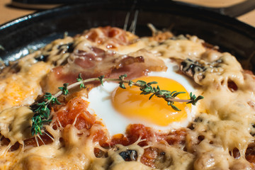 tortilla con potatos. Typical spanish dish with bacon cheese tomato sauce and egg