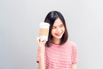 Young girl happy smile and cheerful in red dress hold a white coffee mug in hand. Concept summer travel.