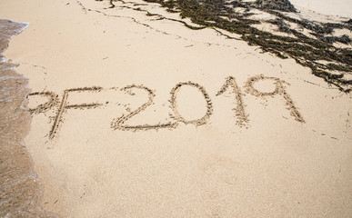 Sand photo written words and numbers on the beach with waves