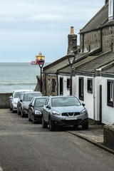 Naklejka premium Aberdeen Scotland, UK. Coastline and ship entering harbour. 