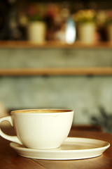 Coffee cup in coffee shop interior